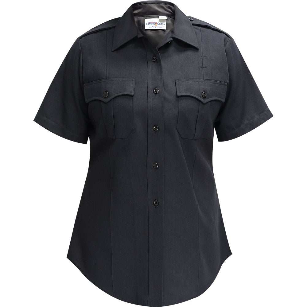 Product shot of a Flying Cross women's short sleeve navy blue uniform shirt featuring a button-down front, two breast pockets, and a curved hem