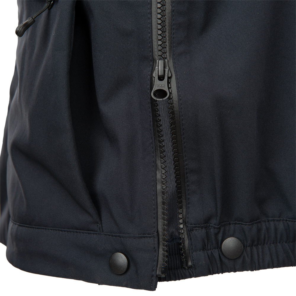 Close-up product shot of a dark navy blue jacket featuring a prominent YKK zipper, black snap buttons, and a textured fabric