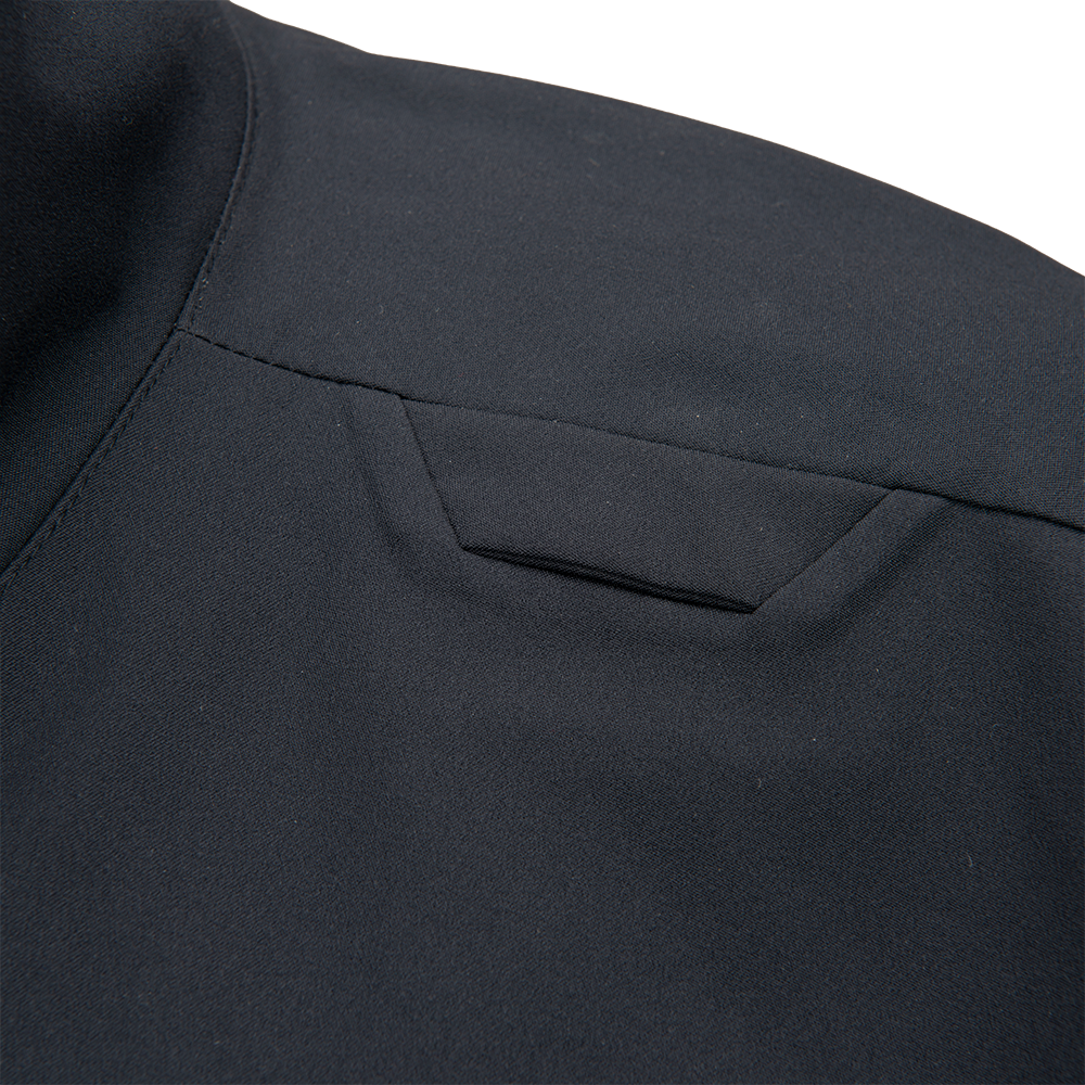 Close-up detail shot of dark grey fabric showing a subtle texture, clean stitching, and a small, angled pocket