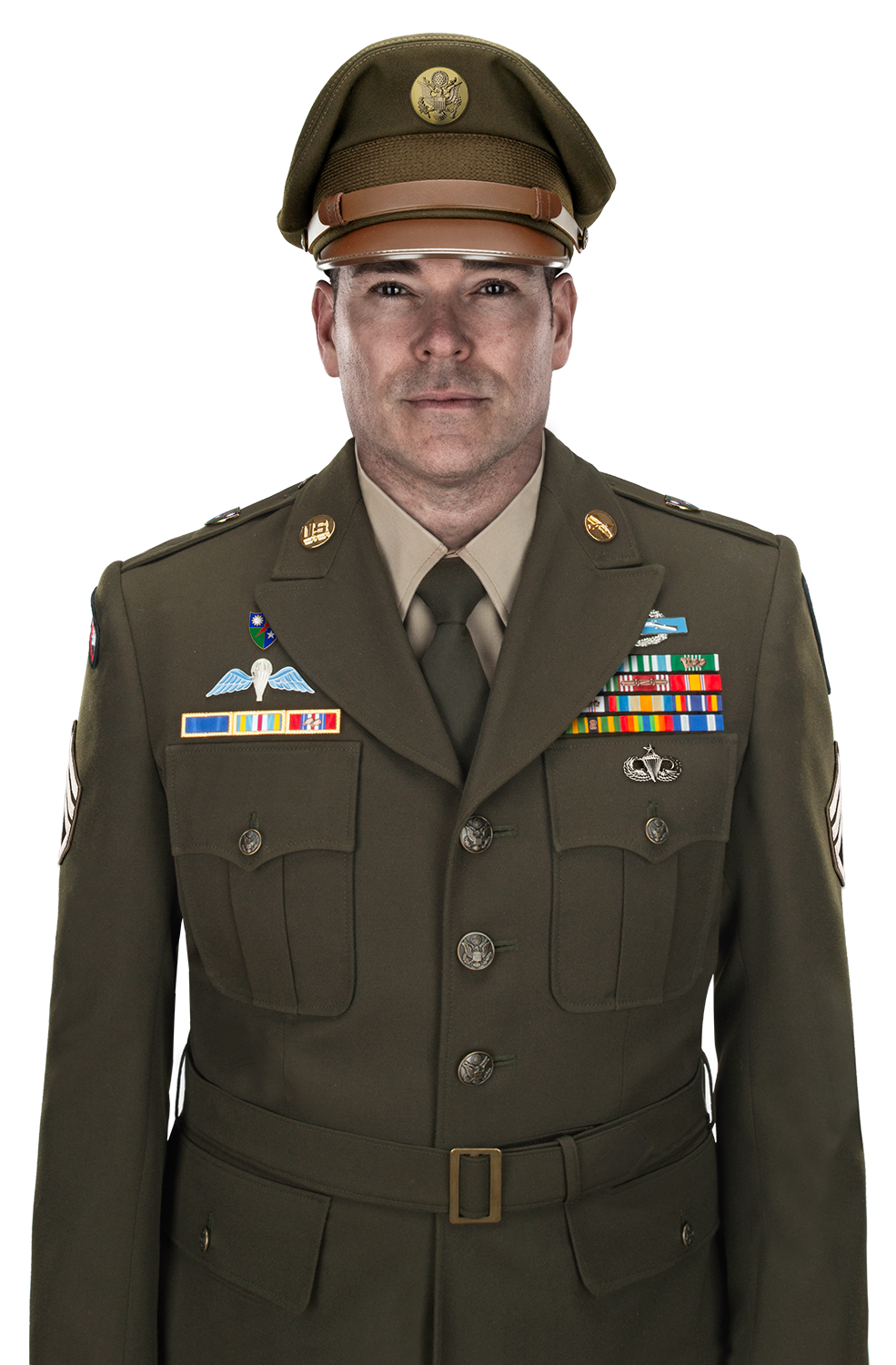 Photo of a US Army Sergeant in Class A uniform featuring a military cap with the US seal, colorful ribbons, and a paratrooper badge against a white background