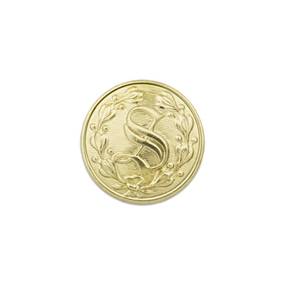 Gold button featuring a embossed capital S encircled by a decorative leaf motif against a textured background