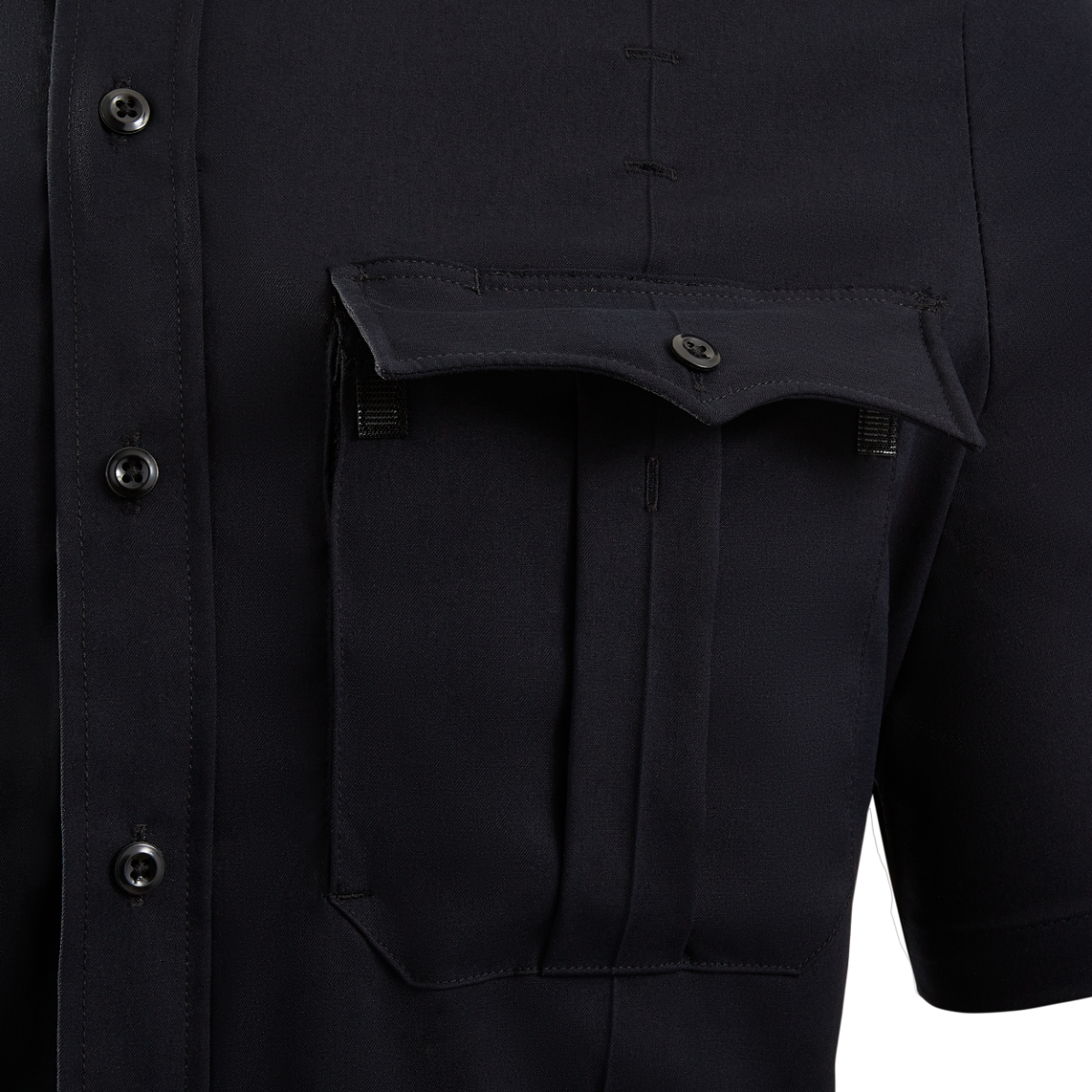 Close-up of a dark navy blue short-sleeved shirt featuring a unique flap pocket, detailed stitching, and dark buttons