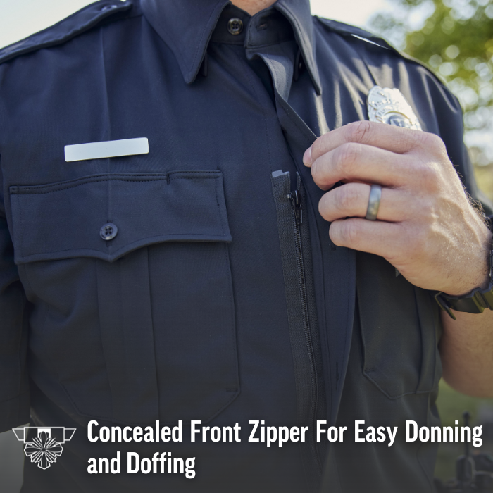 Close-up photograph of a police uniform shirt showing a concealed zipper a name tag and a police badge featuring a dark gray fabric subtle stitching and a dark gray ring