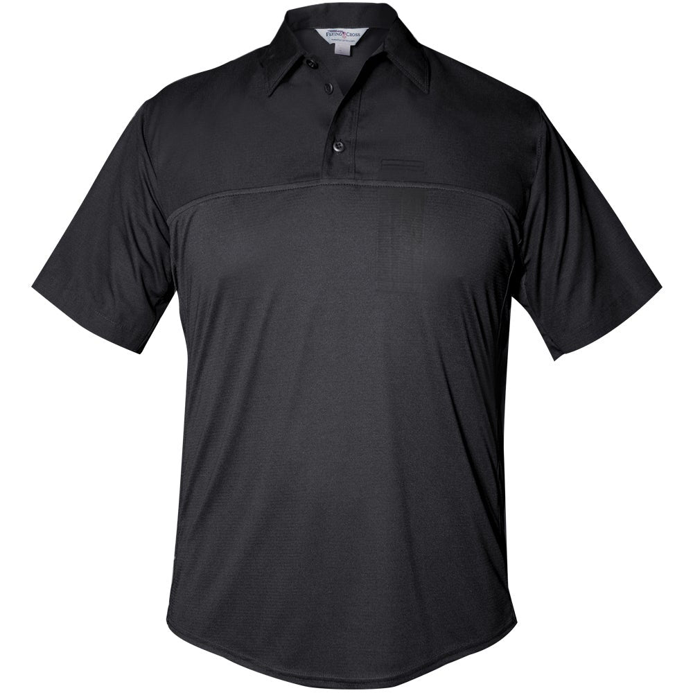 Product shot of a black First Tactical men's short sleeve polo shirt featuring a contrasting textured panel and a small embroidered logo on the chest