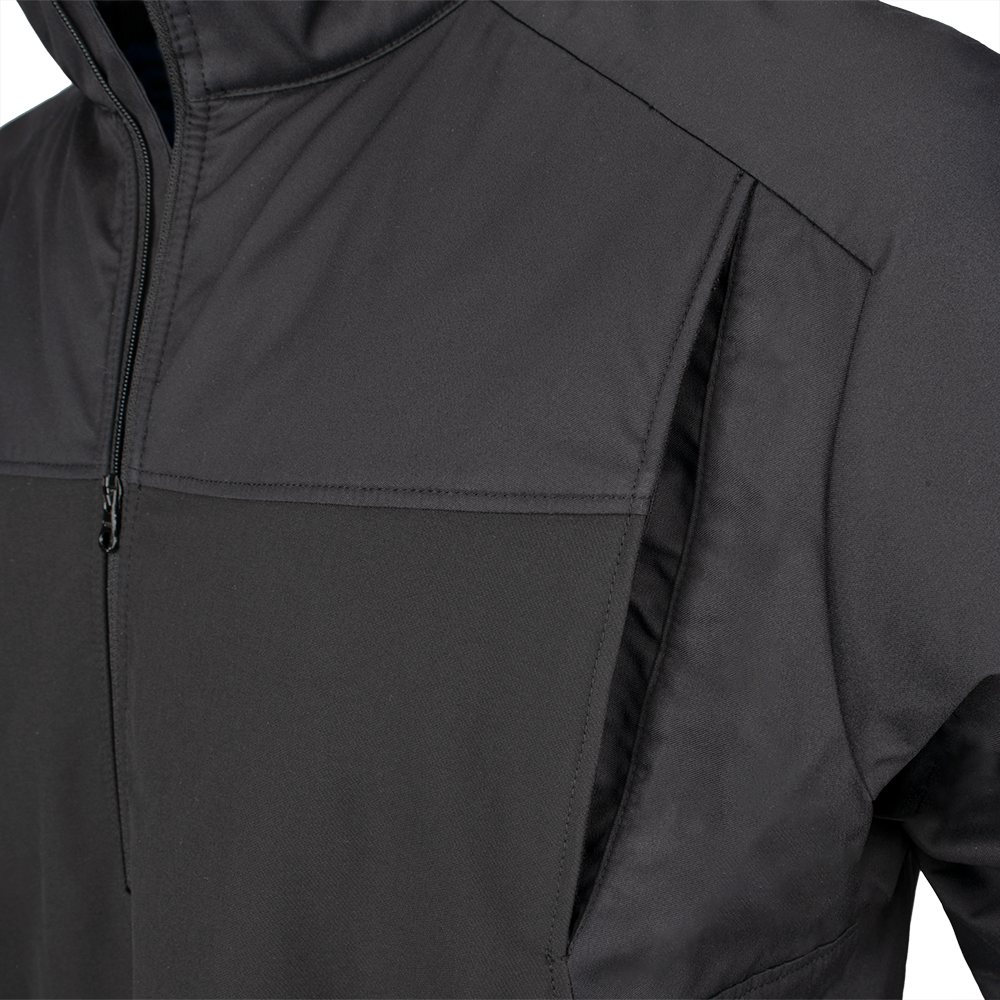 Close-up product shot of a black softshell jacket showing a half zip, contrasting fabric panels, and two hand pockets.