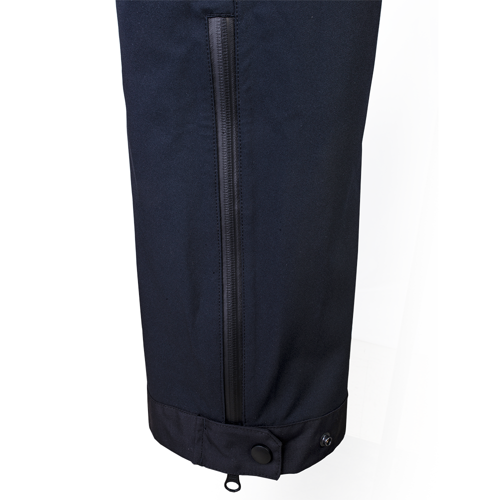 Product shot of black softshell pants featuring a contrasting zipper and button detail against a simple background