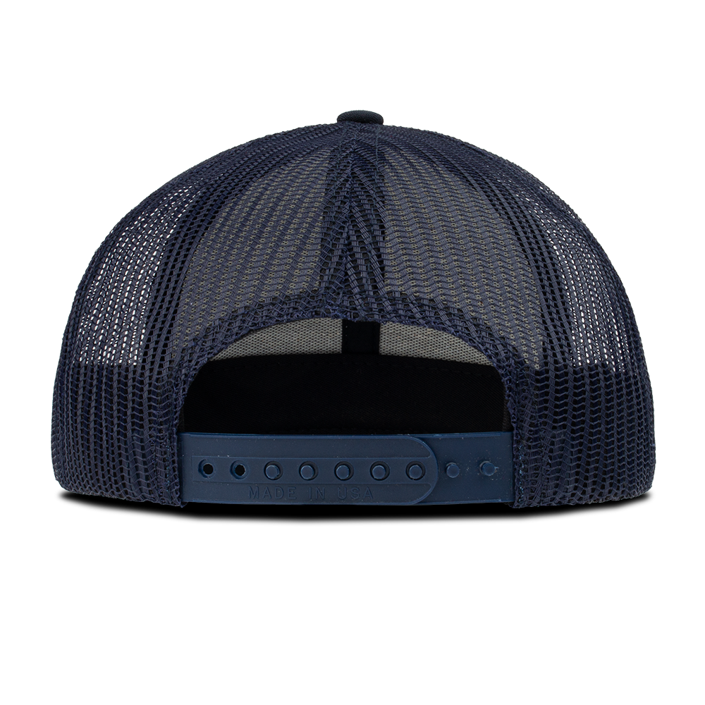 Rear view of a navy blue mesh trucker hat Made in the USA featuring a plastic adjustable strap and a dark crown