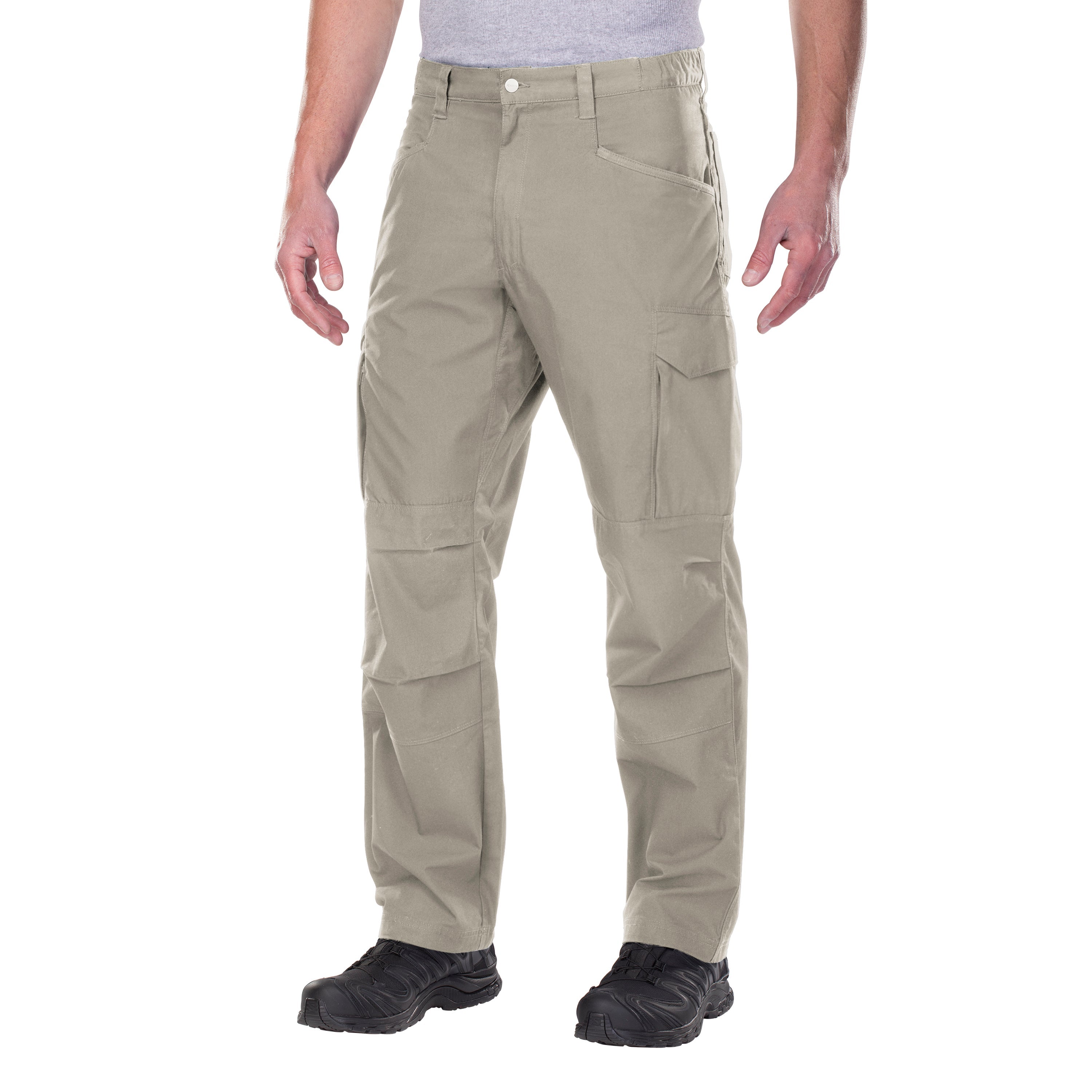 Product shot of tan tactical pants featuring multiple pockets and reinforced knees against a white background worn with black tactical boots showcasing detailed stitching and durable fabric