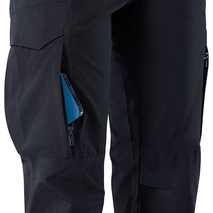 Close-up of dark navy Fjallraven Abisko Trekking Trousers showcasing a zippered pocket with a teal phone a reinforced knee panel and multiple cargo pockets