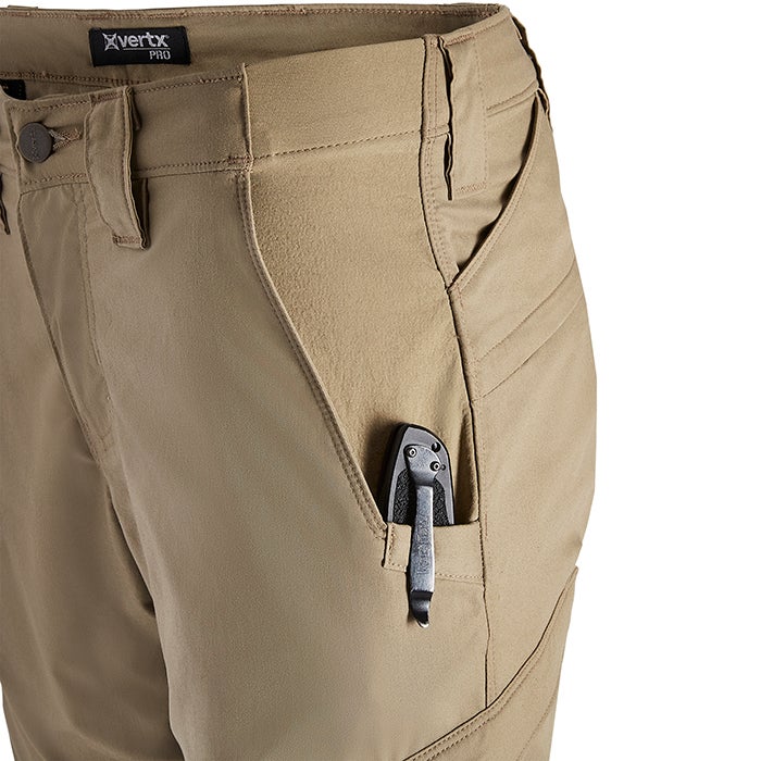 Close-up of tan X Vertx Pro pants showing multiple pockets and a black multi-tool in a side pocket showcasing the durable fabric and reinforced stitching details