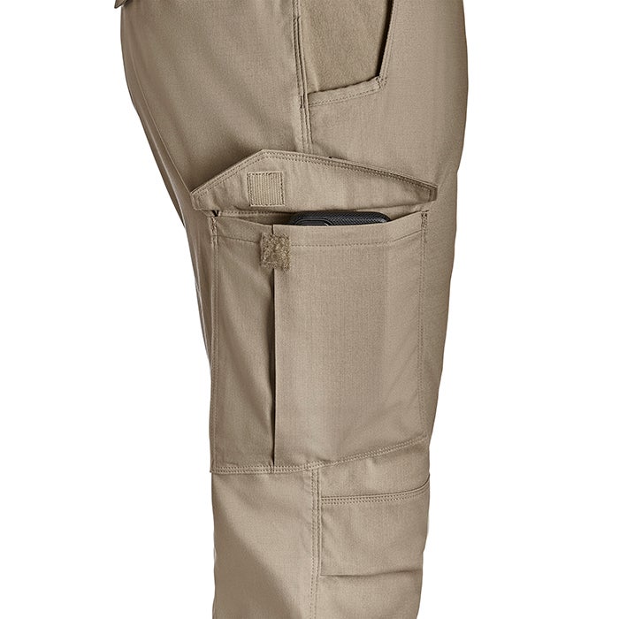 Product shot showing tan tactical pants with multiple pockets a cell phone in one pocket and velcro closures