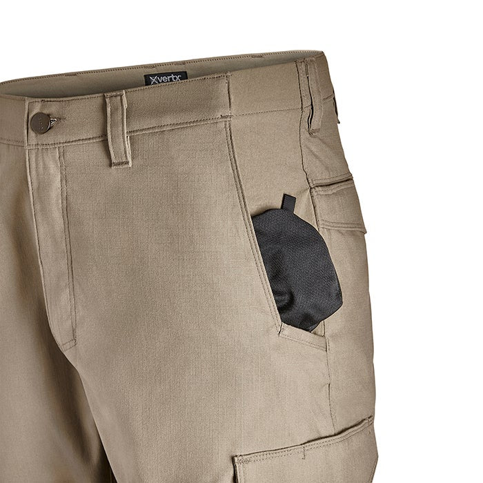 Product shot of tan Vertex tactical pants showing a cargo pocket a black fabric item inside and a branded waistband
