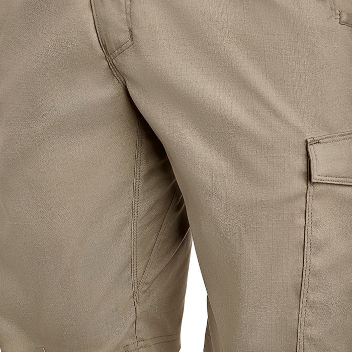 Close-up of tan cargo shorts showing subtle texture, reinforced stitching, and a functional pocket design