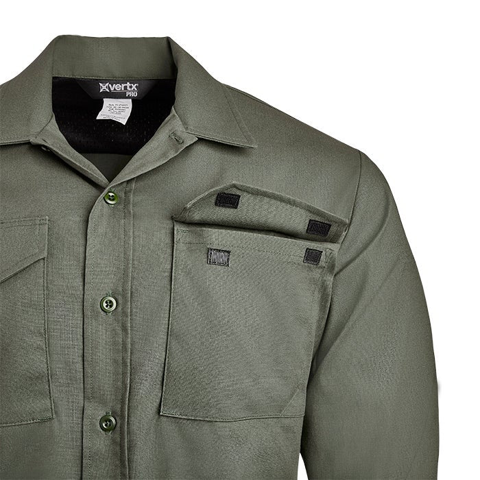 Close-up of a Vertx Pro olive green long-sleeve shirt featuring multiple pockets with black hook-and-loop closures and a textured fabric