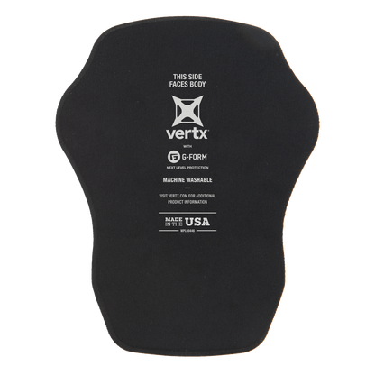 Product shot of a black Vertx G-Form body armor pad featuring the Vertx logo and Made in the USA label with a tan background suggesting packaging
