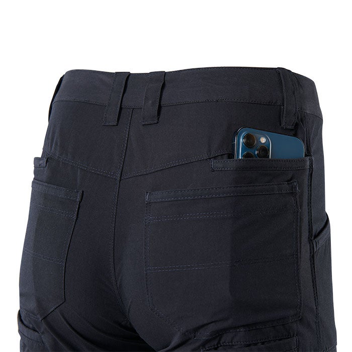 Product shot showing the back of dark-navy pants with multiple pockets a smartphone in one pocket and detailed stitching
