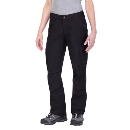 Product shot showing a pair of black women's tactical pants with reinforced knees and multiple pockets featuring a brass button and light blue accents on gray hiking boots against a white background
