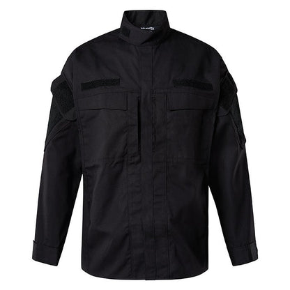 Product shot of a black tactical long-sleeve shirt with Velcro patches and pen pockets showing subtle texture and a hint of sheen on the fabric
